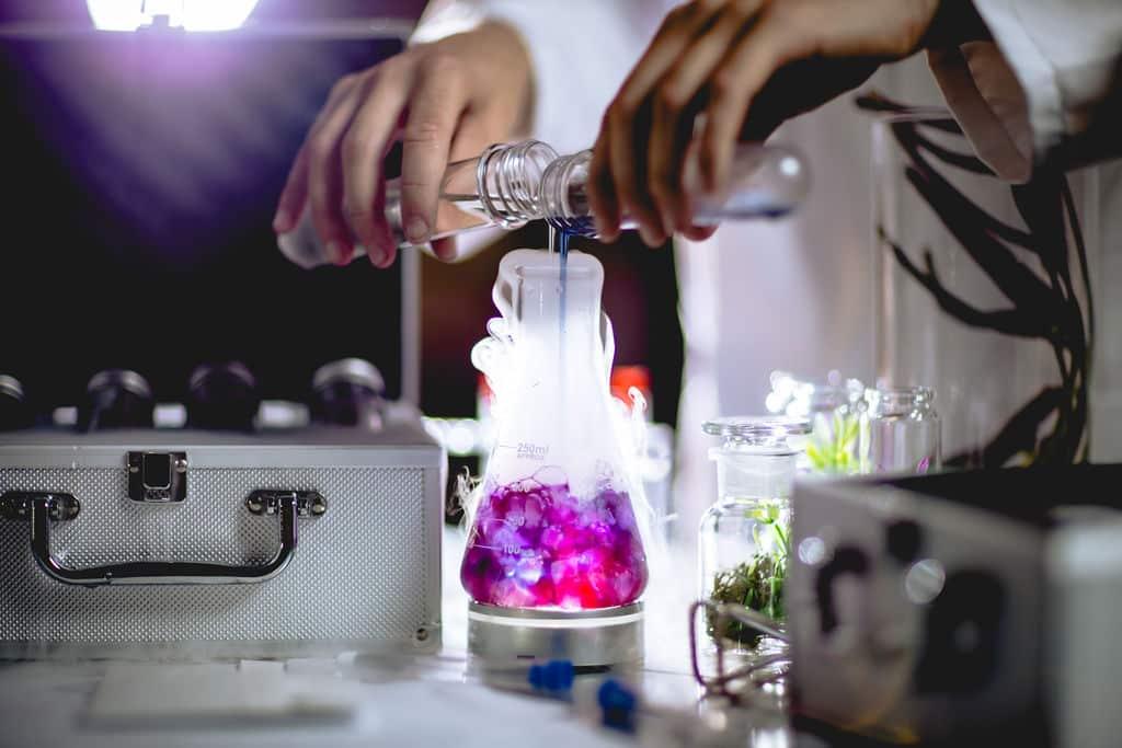 Someone pouring some drinks and spirits into a glass at Avora