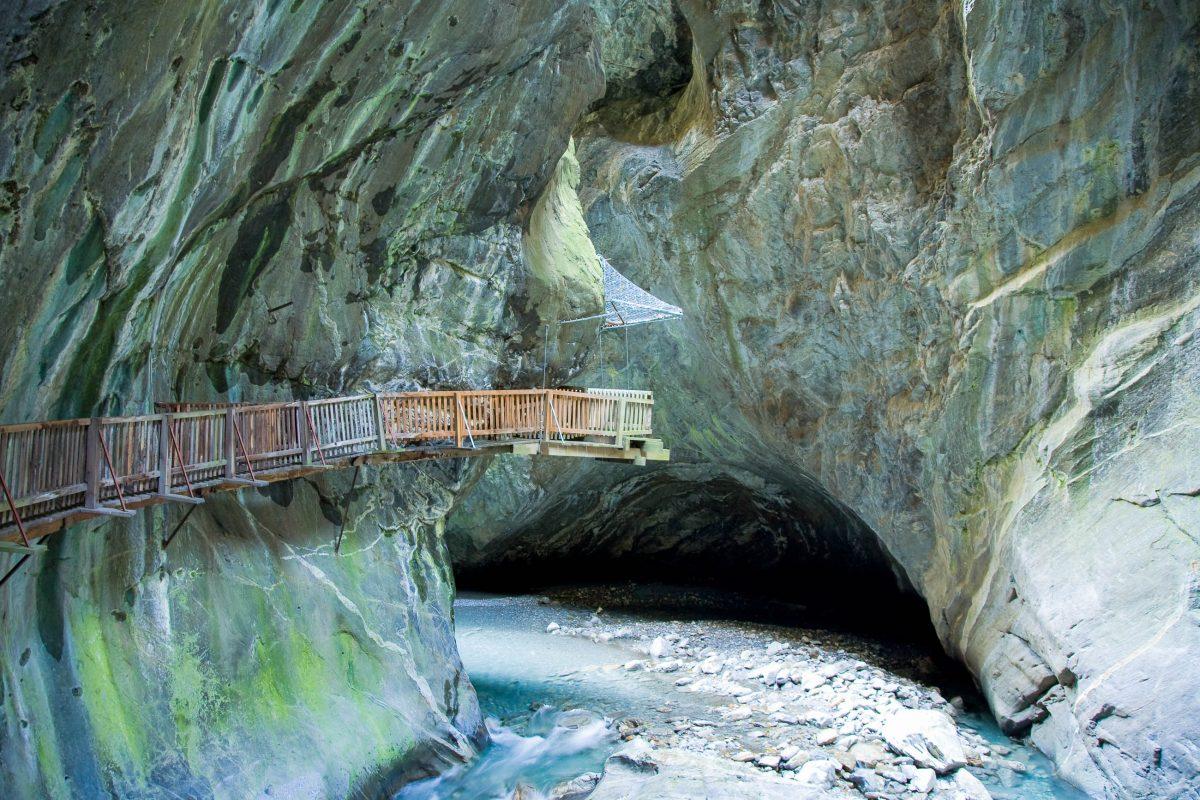 The 200m-deep Trient Gorge in the can be visited on a footbridge along the vertically rising mountain face and leads to a breathtaking waterfall, Switzerland - © Roland Zihlmann / Shutterstock